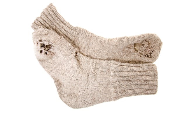 Old socks with holes chewed in them by moths