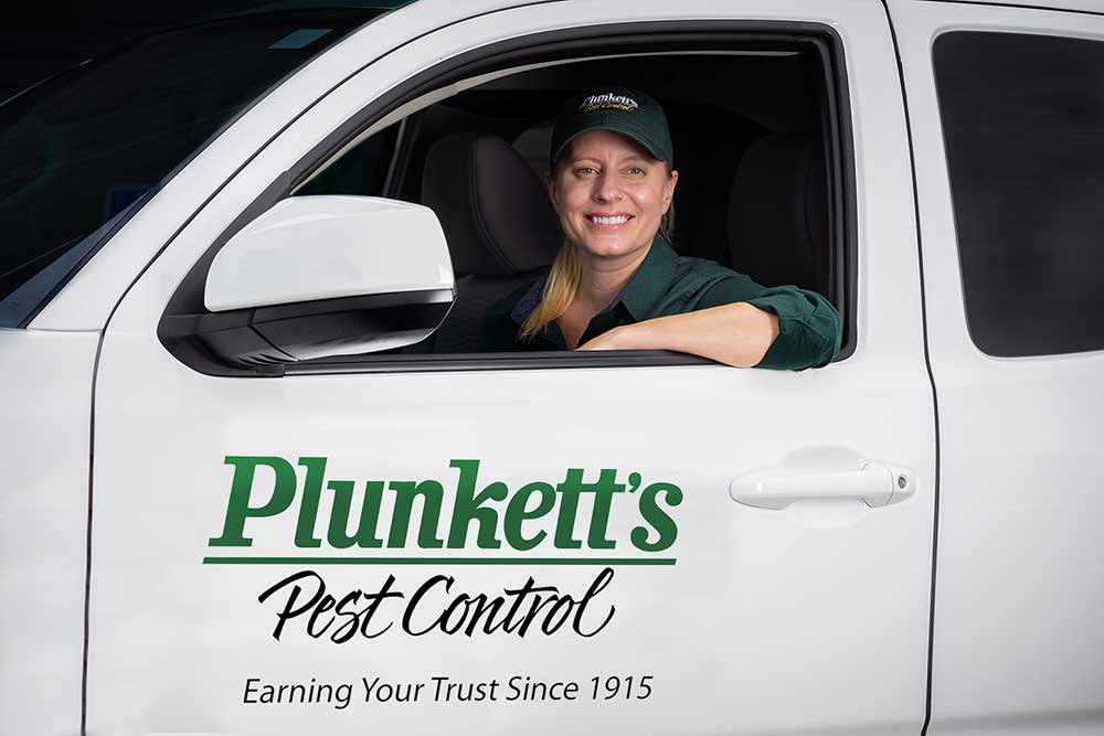 Female Pest Control Tech In Service Truck