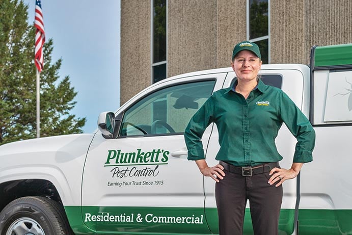 Female Tech Standing By Truck