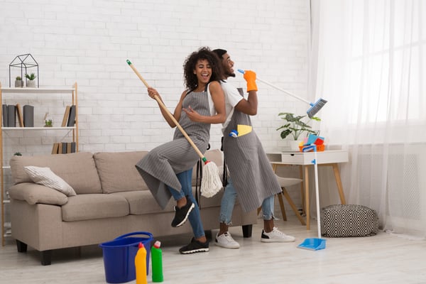 Man and woman spring cleaning in their home